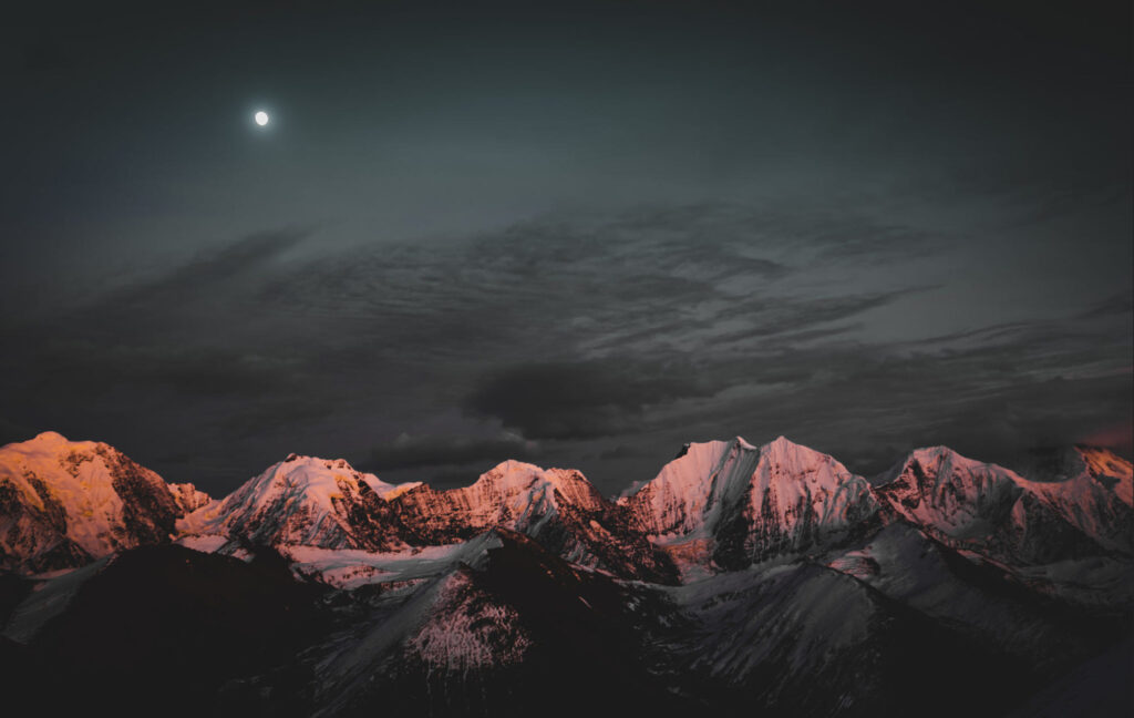 Gongga Peaks with sun and moon